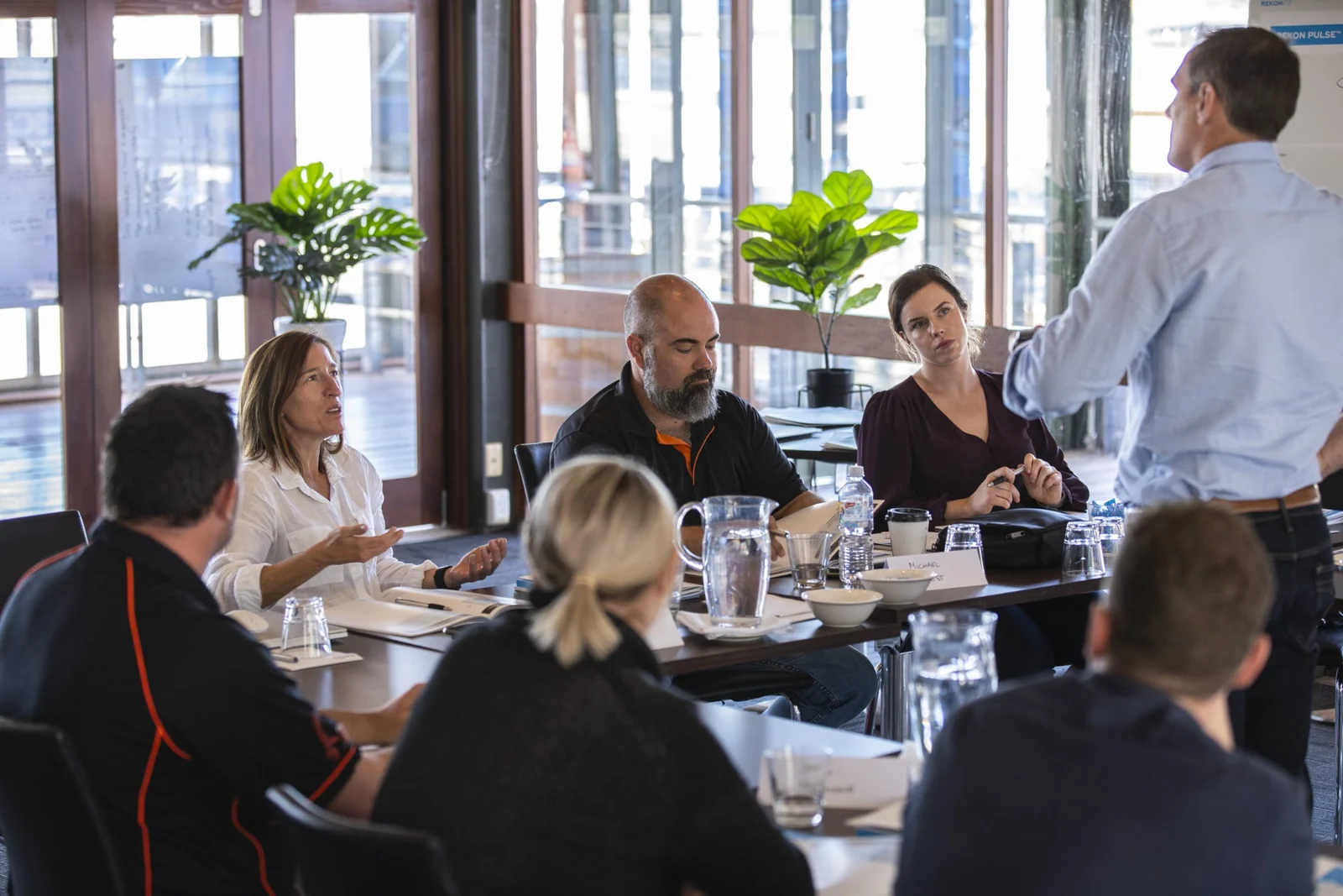 Rekon facilitator teaching leaders around a workshop table
